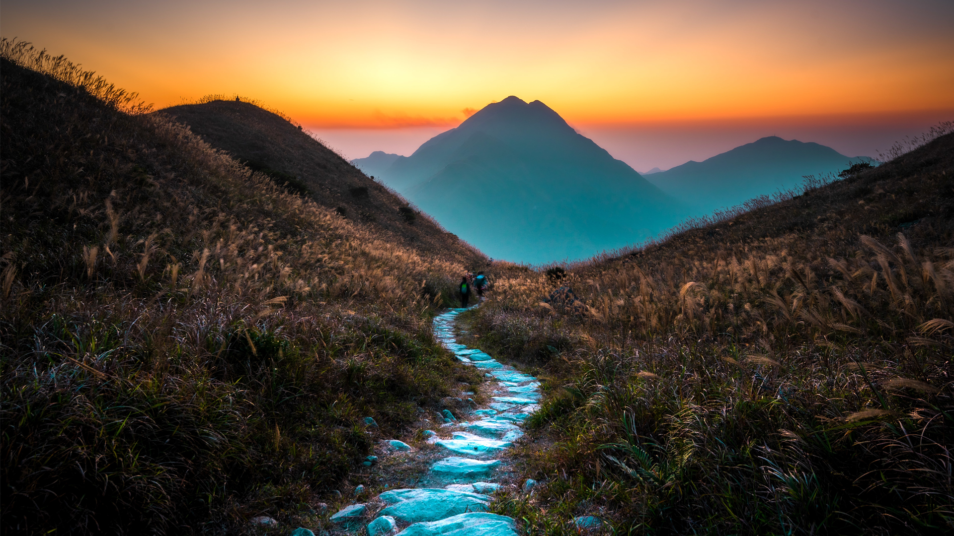 Trail leads into a valley at sunset